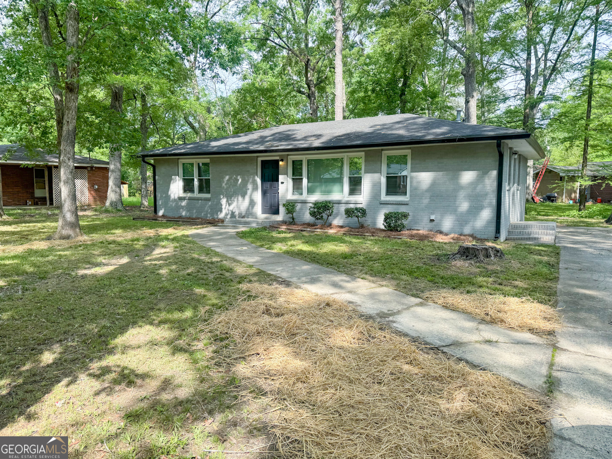 a front view of a house with a garden