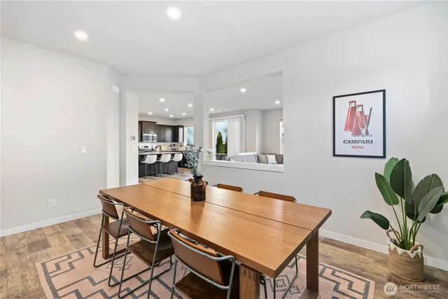 a dining room with furniture and a potted plant