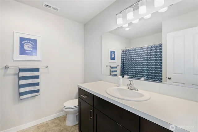 a bathroom with a sink toilet and a mirror