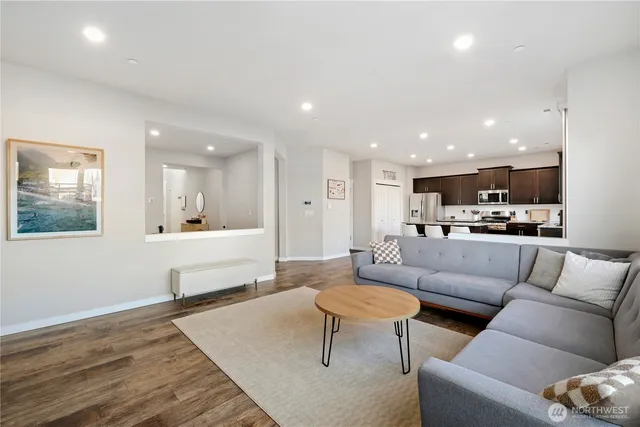 a living room with furniture and kitchen view