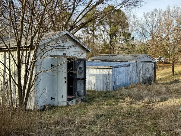 a house view with backyard and tree