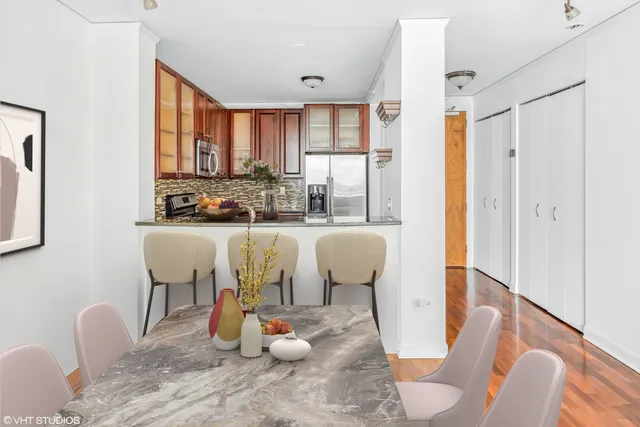 a view of a dining room with furniture large windows and wooden floor