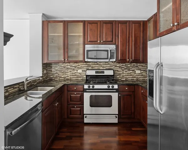 an empty room with cabinet and ceiling fan