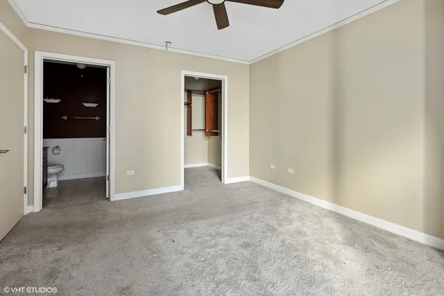 a bathroom with a granite countertop sink a mirror and a toilet