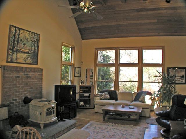55 Bliven Road Otis, MA 01253 - Photo 4 of 15 a living room with furniture a flat screen tv and a floor to ceiling window