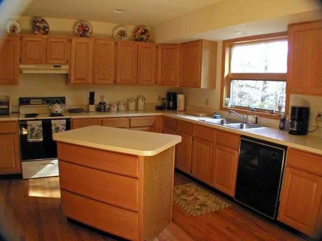 55 Bliven Road Otis, MA 01253 - Photo 8 of 15 a kitchen with a sink stove and cabinets