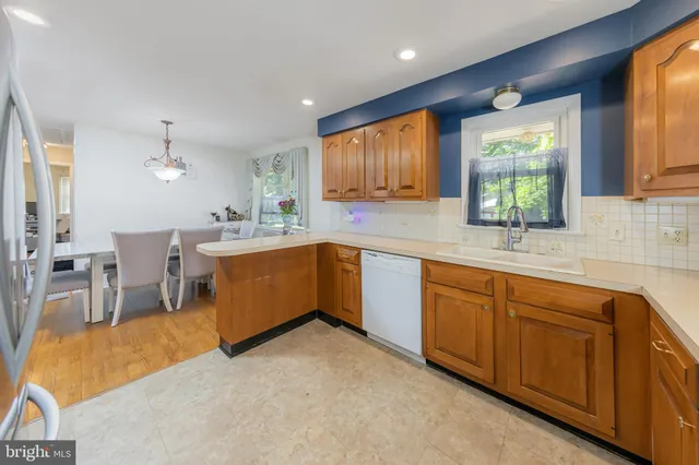 a kitchen with a sink window and cabinets
