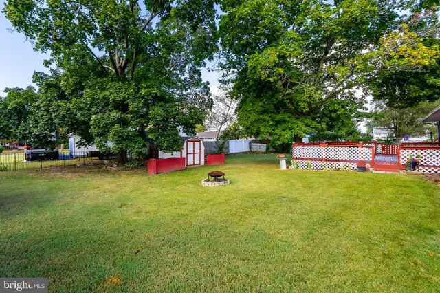 a backyard of a house with childrens swings and slides