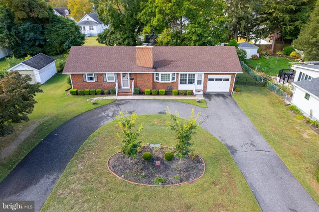 an aerial view of a house with a swimming pool yard and outdoor seating