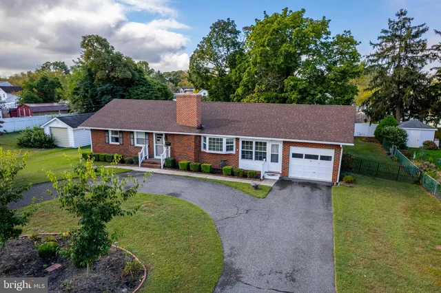 an aerial view of a house with garden space and street view