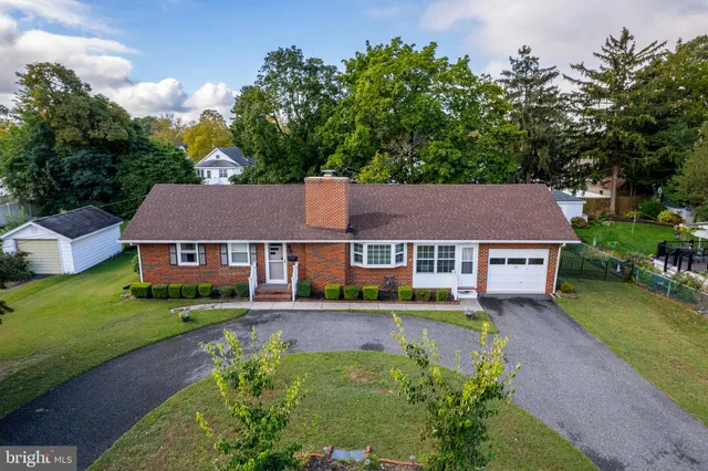 an aerial view of residential houses with outdoor space and street view