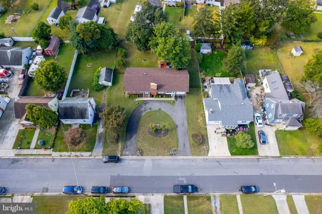 an aerial view of multiple houses with yard