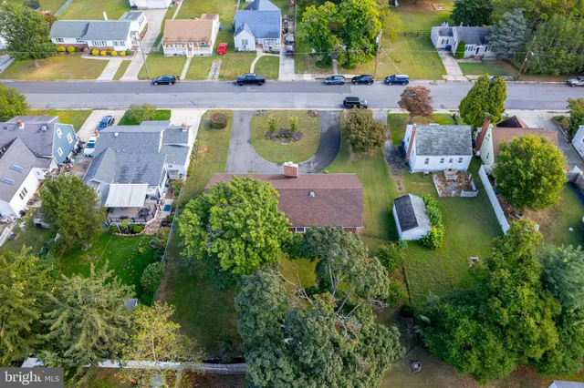 an aerial view of a house with a swimming pool patio and outdoor seating