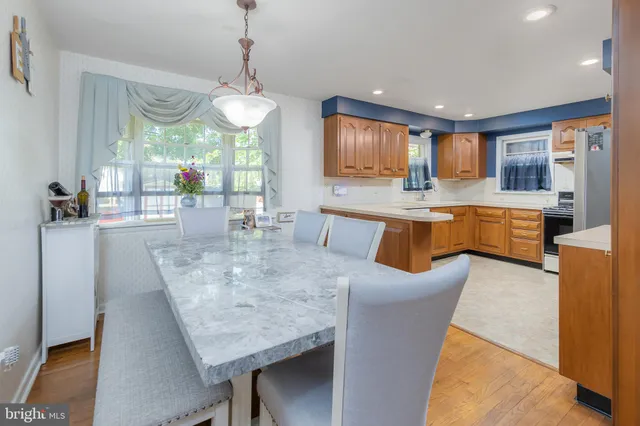 a dining table with chairs and window