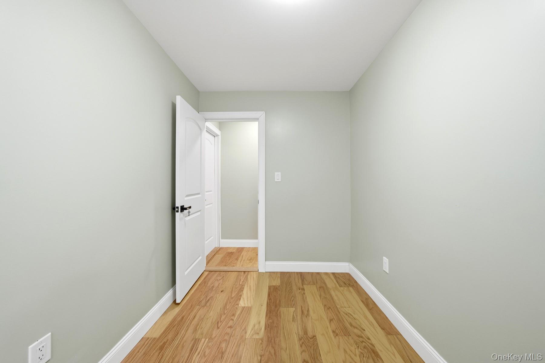 104-11 205th Street Queens, NY 11412 - Photo 28 of 50 Spare room with light wood-style floors and baseboards