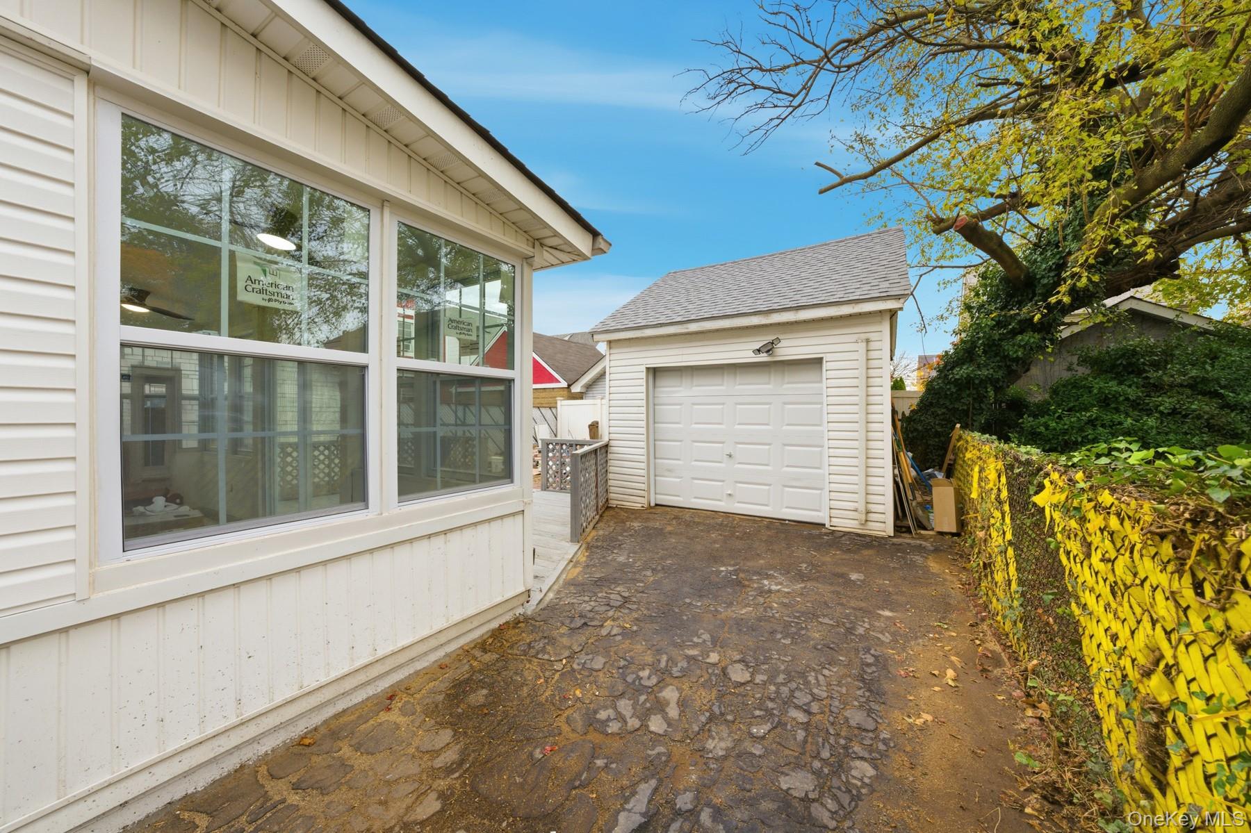 104-11 205th Street Queens, NY 11412 - Photo 48 of 50 Detached garage featuring asphalt driveway