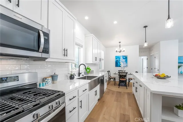 a kitchen with lots of counter top space and stainless steel appliances