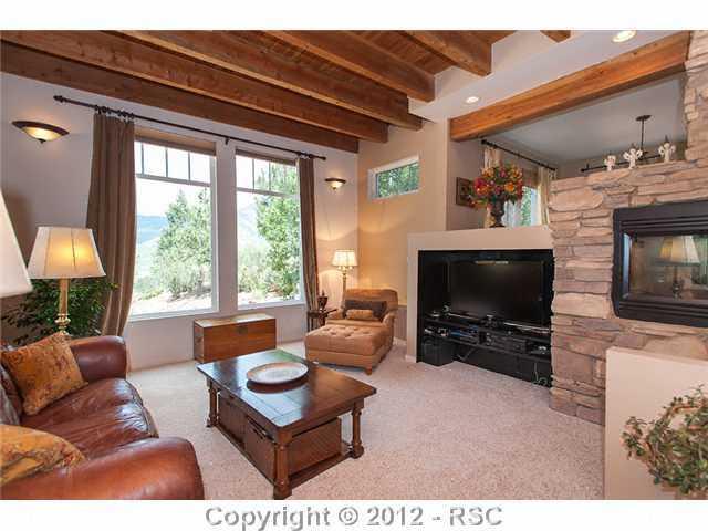 5610 Timpa Road Cascade, CO 80809 - Photo 6 of 16 Another view of the living room located to the back of the home and adjacent to the dining room and den.