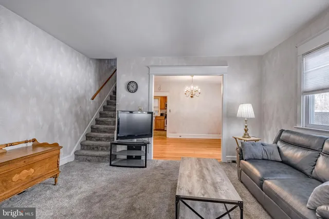 a living room with furniture and a chandelier