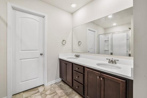 292 Whitetail Circle Canton, GA 30115 - Photo 16 of 17 a bathroom with double sink and a mirror