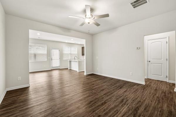 292 Whitetail Circle Canton, GA 30115 - Photo 2 of 17 an empty room with wooden floor ceiling fan and windows