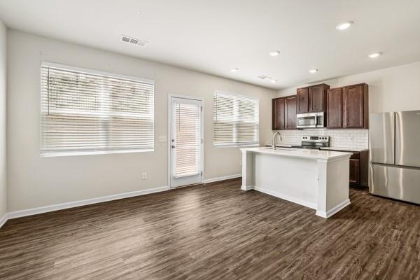 292 Whitetail Circle Canton, GA 30115 - Photo 5 of 17 a kitchen with stainless steel appliances a refrigerator sink and cabinets