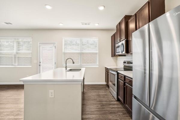 292 Whitetail Circle Canton, GA 30115 - Photo 6 of 17 a kitchen with stainless steel appliances a refrigerator sink and cabinets