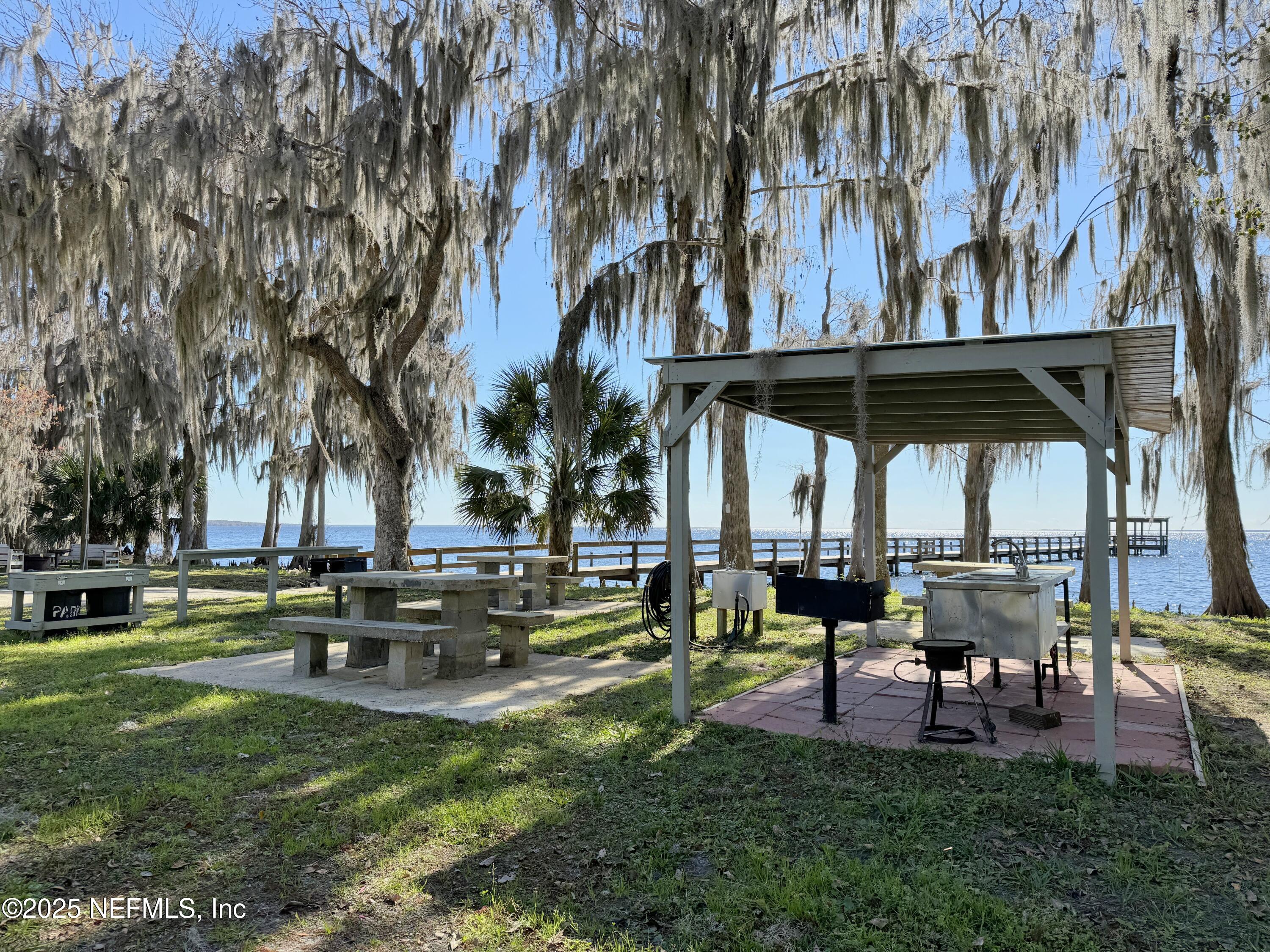 136 Helen Avenue Georgetown, FL 32139 - Photo 21 of 25 a view of a table and chairs in the garden