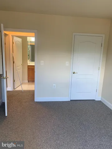 an empty room with sliding door and mirror