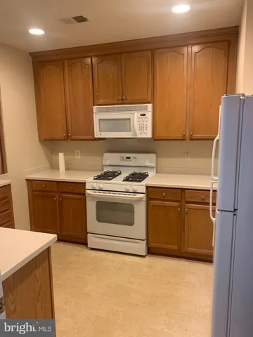 a kitchen with a stove a sink and a refrigerator