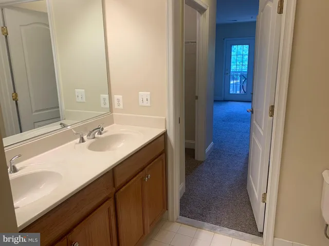 a bathroom with a sink double vanity and a mirror