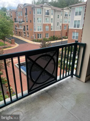 a view of a balcony with an outdoor seating