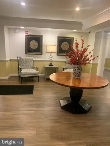 a living room with furniture and flowers