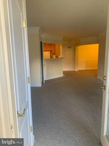a view of hallway with wooden floor