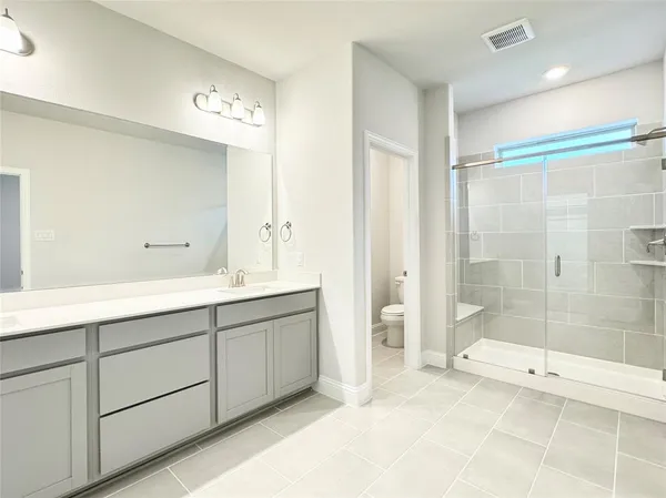 a bathroom with a double vanity sink and a mirror