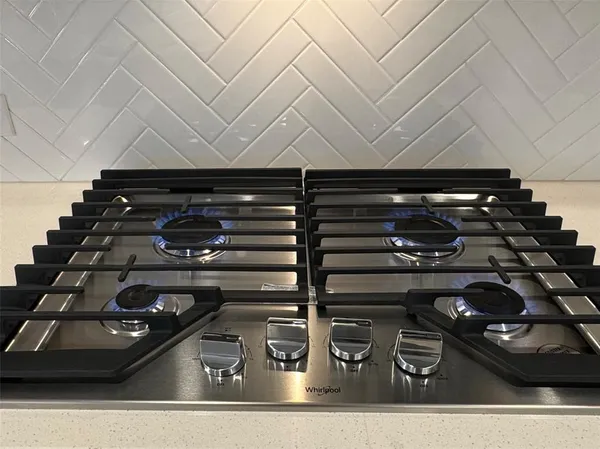 a kitchen with kitchen island granite countertop a stove and a sink