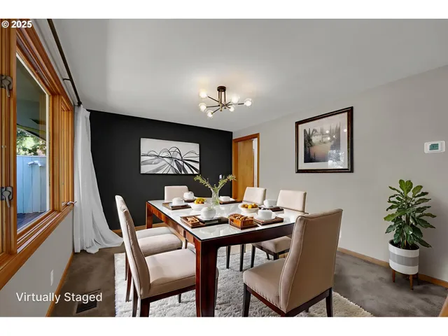 a dining room with furniture potted plants and wooden floor