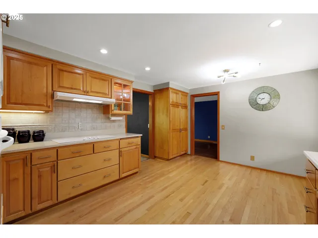 a kitchen with cabinets and wooden floor