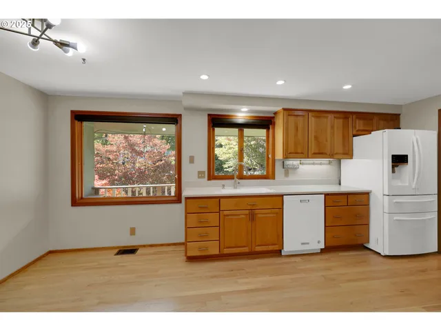 a kitchen with stainless steel appliances granite countertop a stove a sink and a refrigerator
