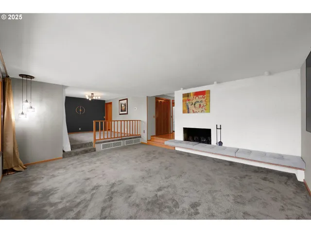 a view of an empty room with a fireplace