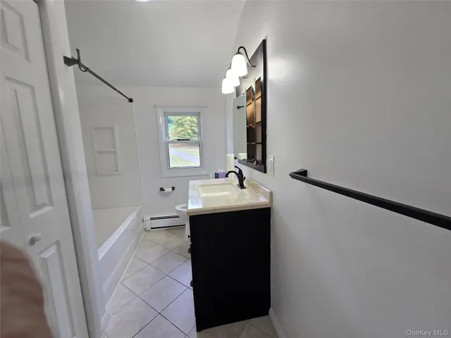 a bathroom with a sink and mirror