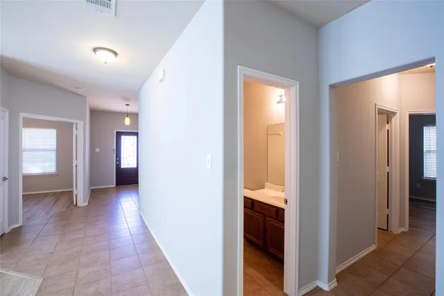 a view of a hallway with wooden shelves