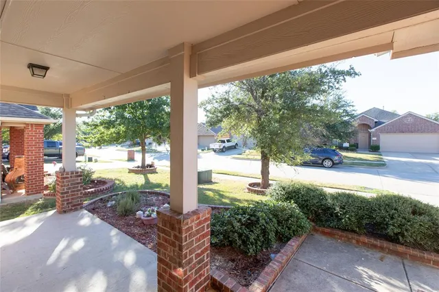 a view of a porch with furniture and garden