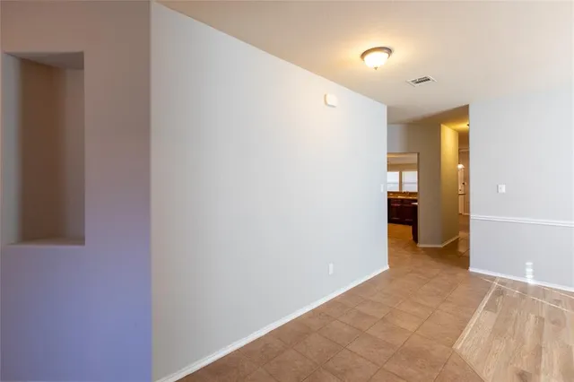 a view of hallway with a bathroom
