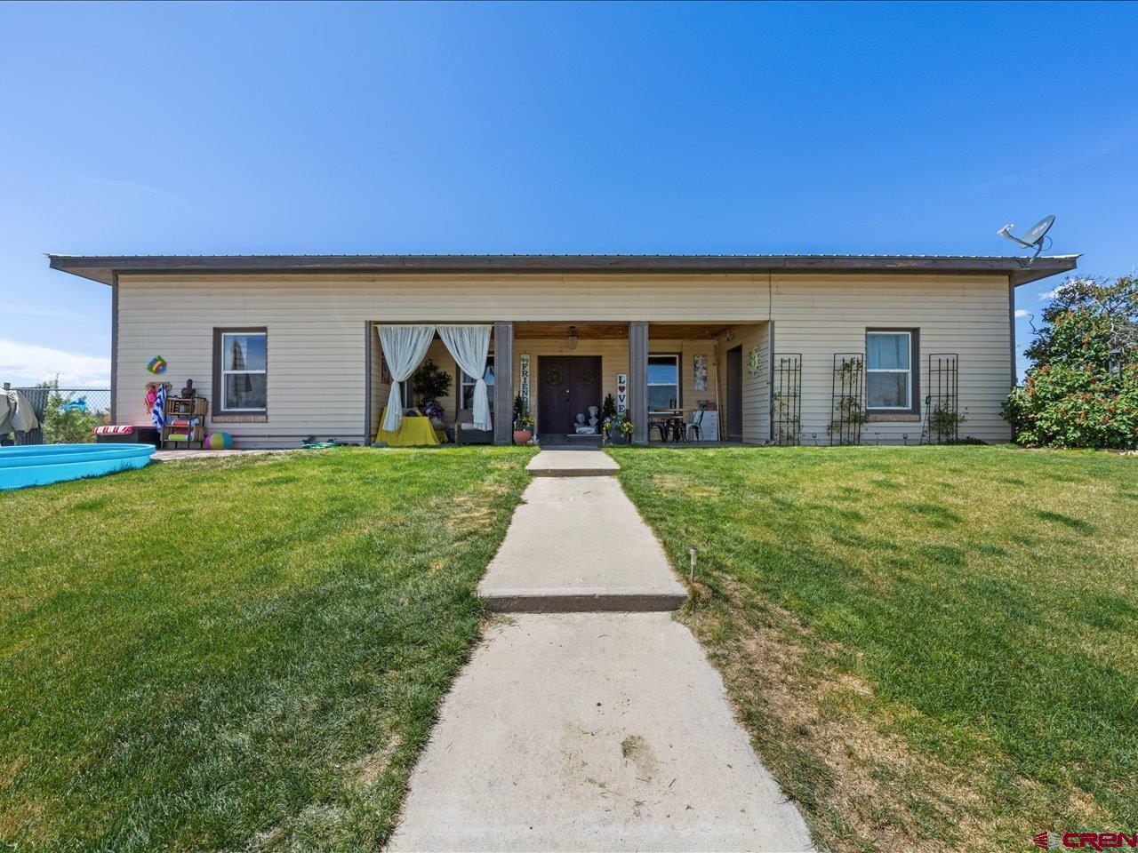 a view of a yard and front view of a house
