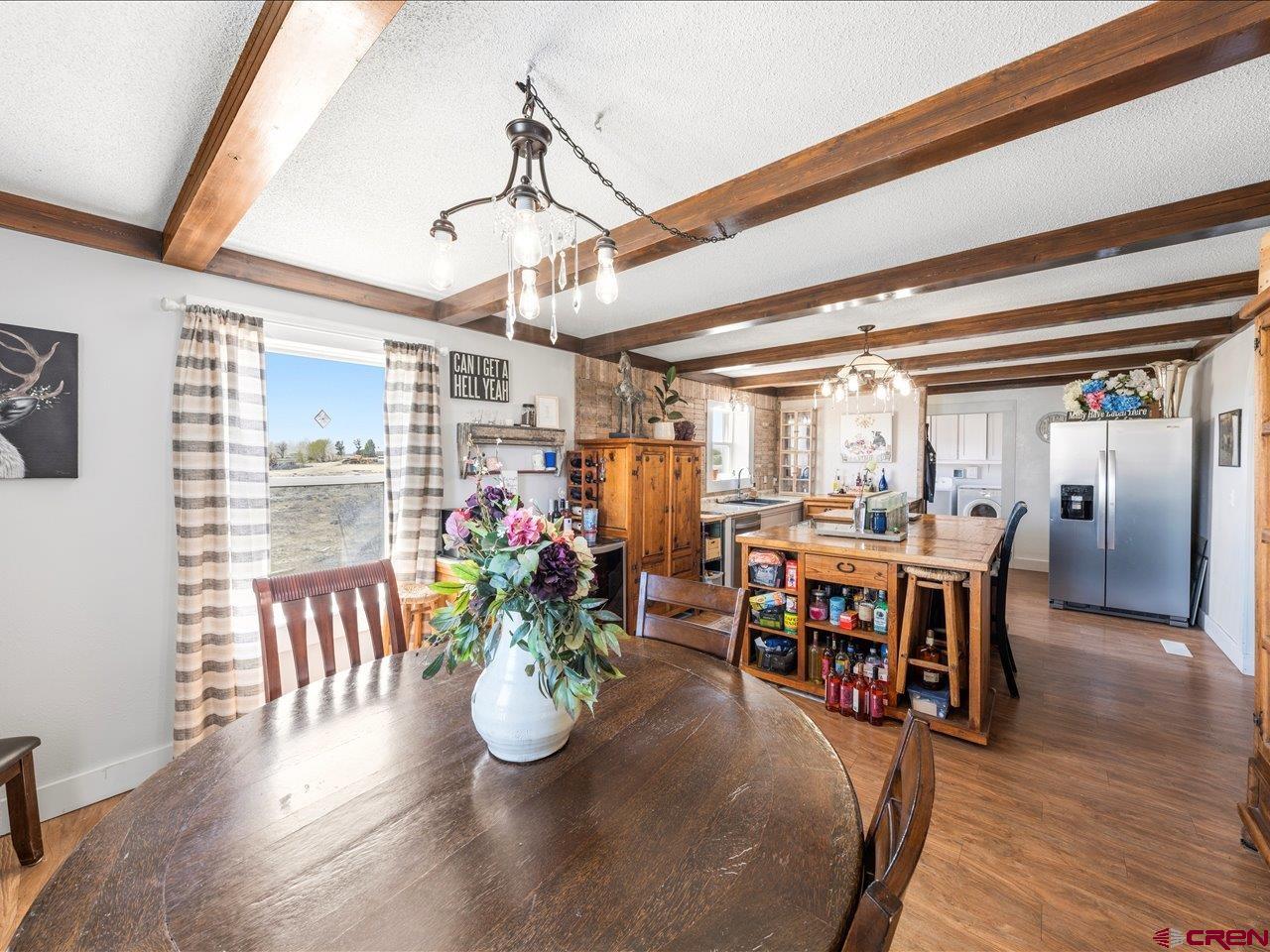 22244 F Road Delta, CO 81416 - Photo 15 of 41 a view of a dining room with furniture window and wooden floor