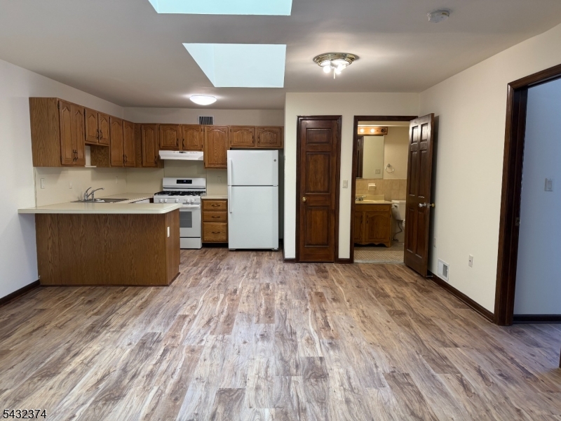 551 Valley Road, Unit 2 Montclair, NJ 07043 - Photo 2 of 9 a view of kitchen with stainless steel appliances granite countertop a refrigerator and a stove top oven