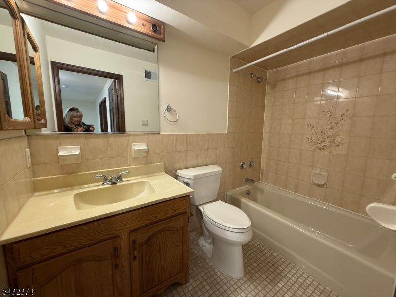 551 Valley Road, Unit 2 Montclair, NJ 07043 - Photo 6 of 9 a bathroom with a sink a toilet and shower