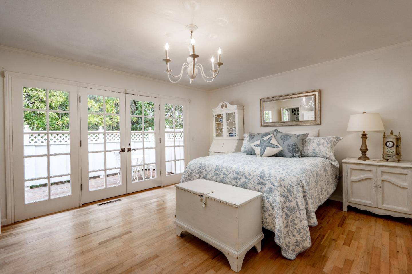 2952 Stevenson Drive Pebble Beach, CA 93953 - Photo 11 of 23 a spacious bedroom with a large bed and a chandelier