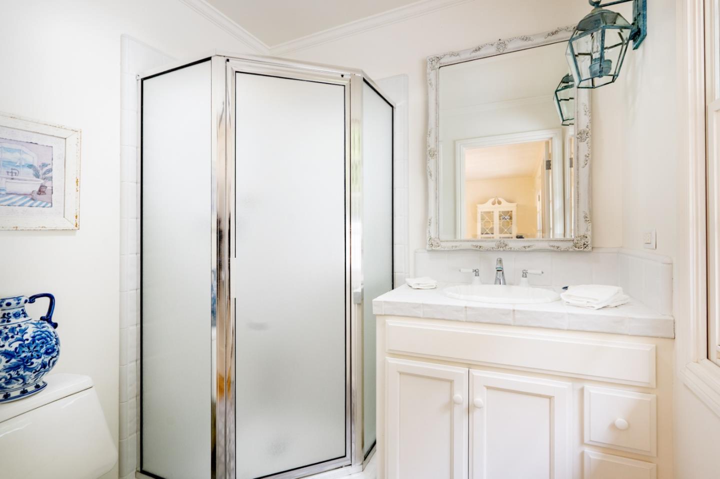 2952 Stevenson Drive Pebble Beach, CA 93953 - Photo 13 of 23 a bathroom with a sink mirror and a shower